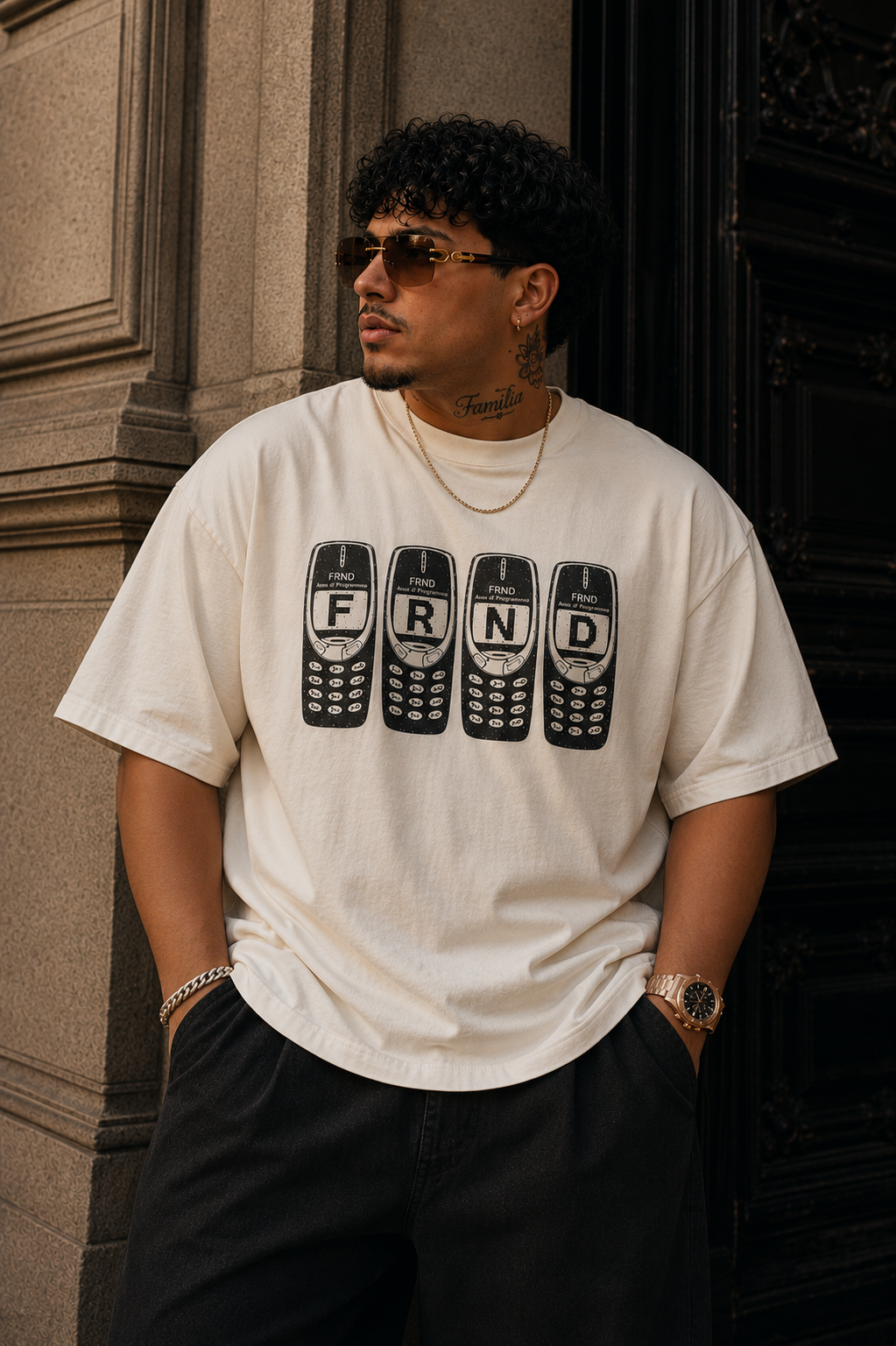 Model wearing the FRND Brick Phone Tee outside a stone building
