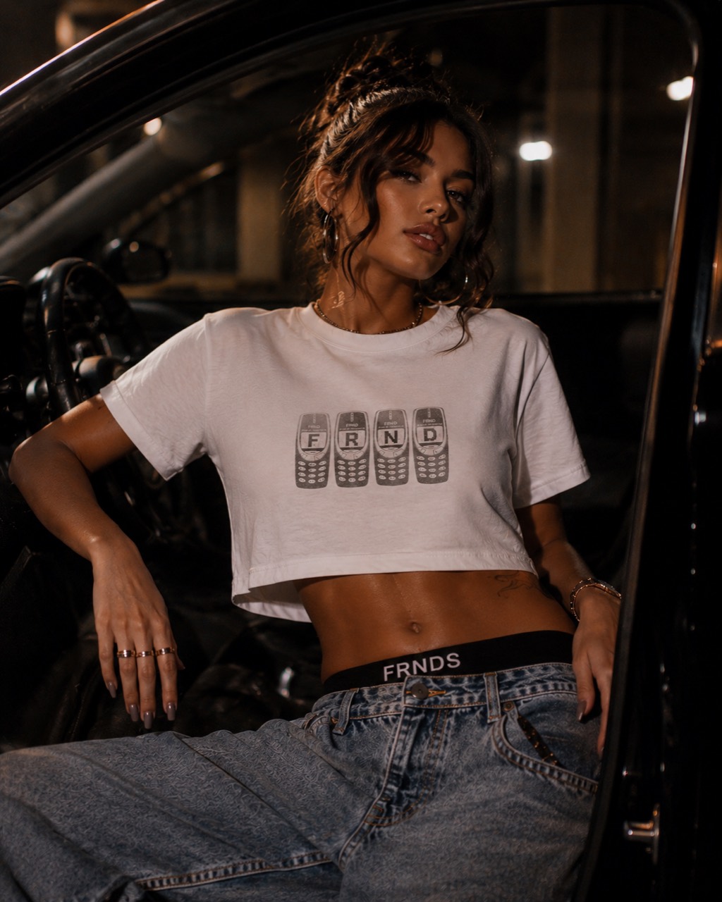 Model wearing the FRNDS Brick Phone Crop Tee