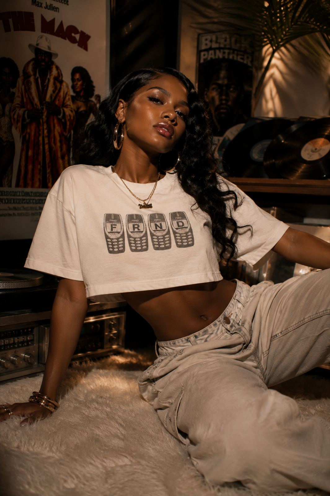 Model wearing the white FRNDS brick phone crop tee in a record room editorial