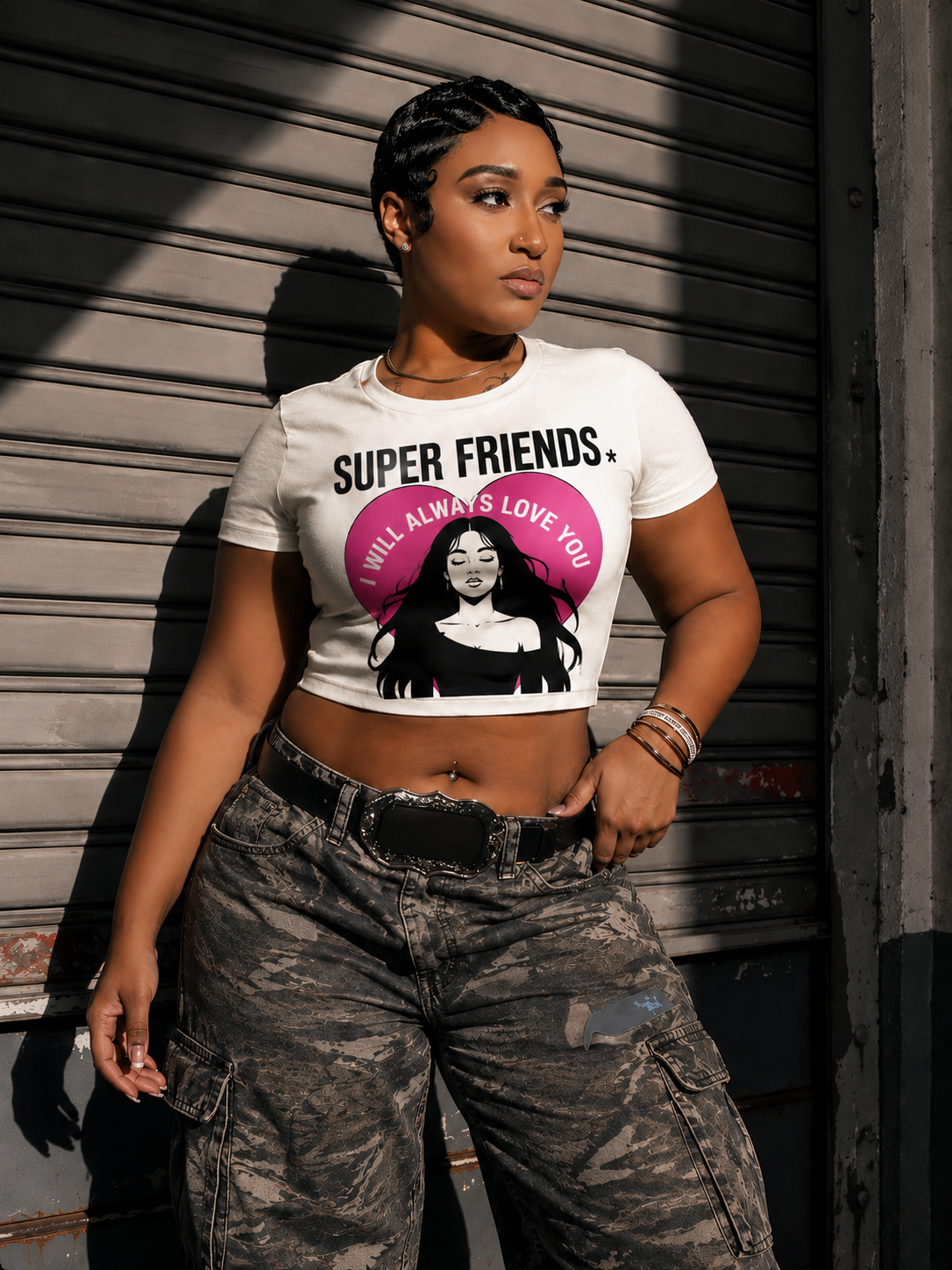 Model wearing the white Super Friends crop top against a textured wall