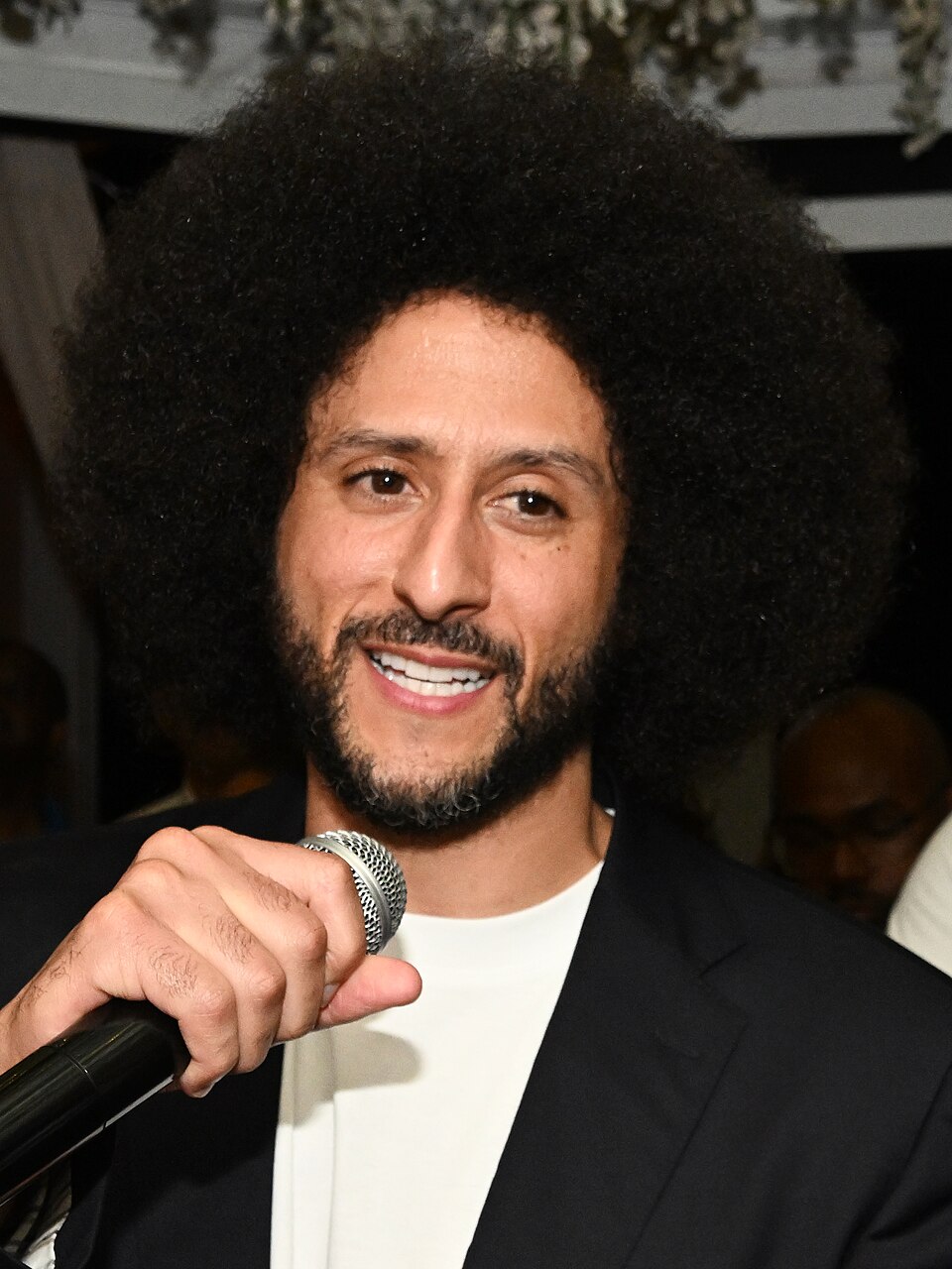 Colin Kaepernick speaking into a microphone